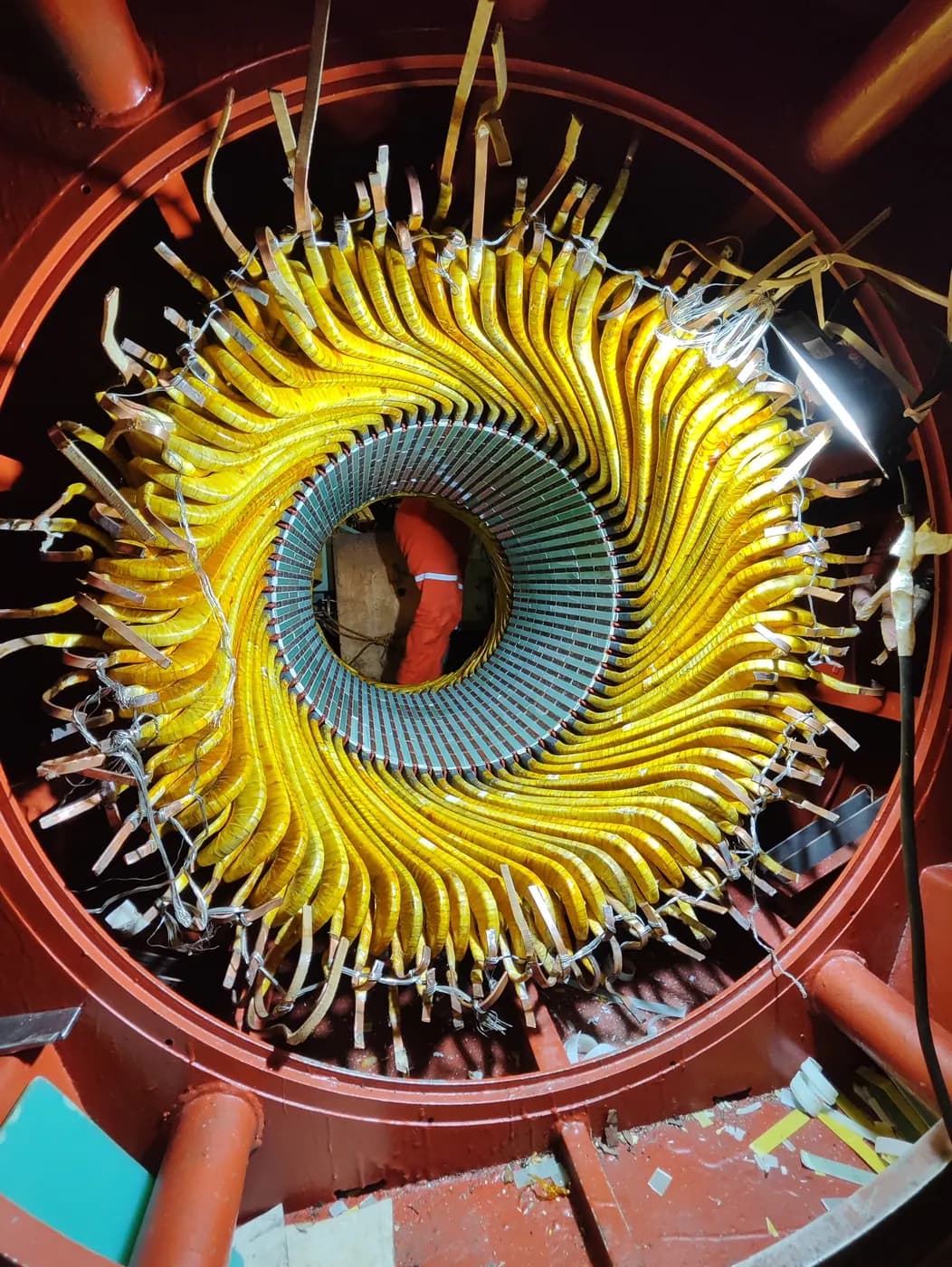 Yellow coil ends forming a spiral inside a generator stator