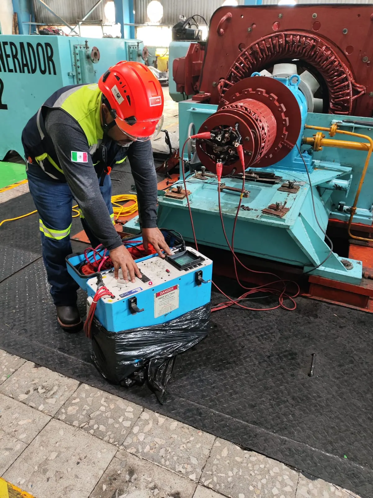 Technician connecting electrical test equipment to a generator